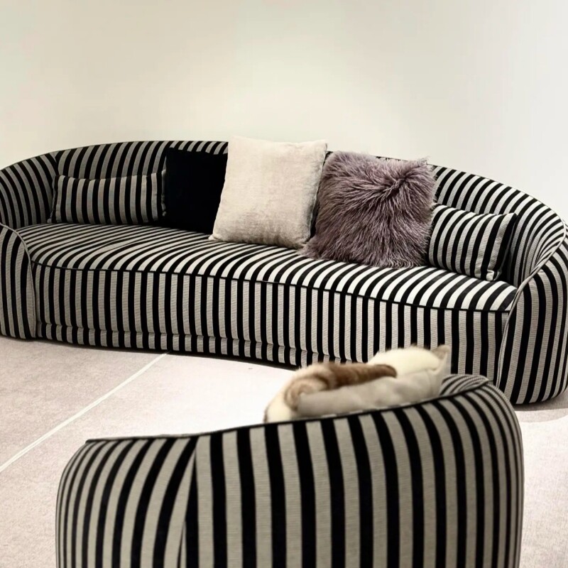Black and Cream Striped Curved Sofa with Rounded Tubular Arms